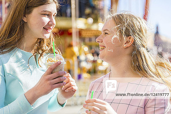 Russia  Moscow  teenage girls drinking a delicious frappe at funfair