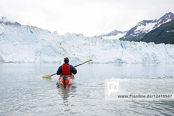 USA  Alaska  Valdez  man in canoe on glacial lake