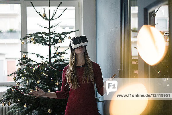Woman using Virtual Reality Glasses at Christmas time