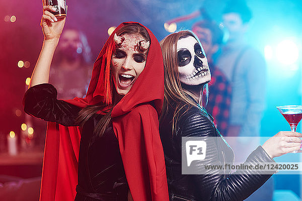 Women in creepy costumes dancing at Halloween party