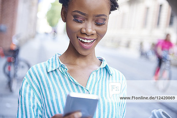 Portrait of smiling woman looking at cell phone