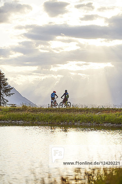 Austria  Tyrol  Mountainbikers in the evening light