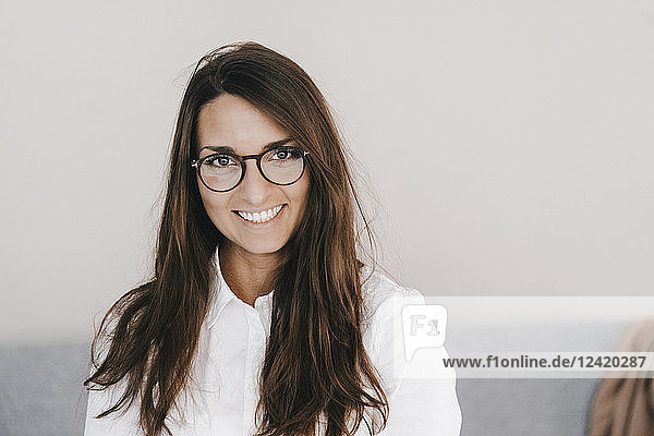 Portrait of a pretty clever young woman wearing glasses