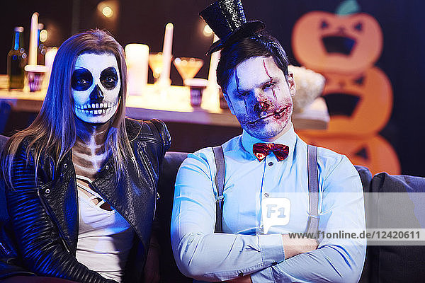 Portrait of spooky couple at Halloween party