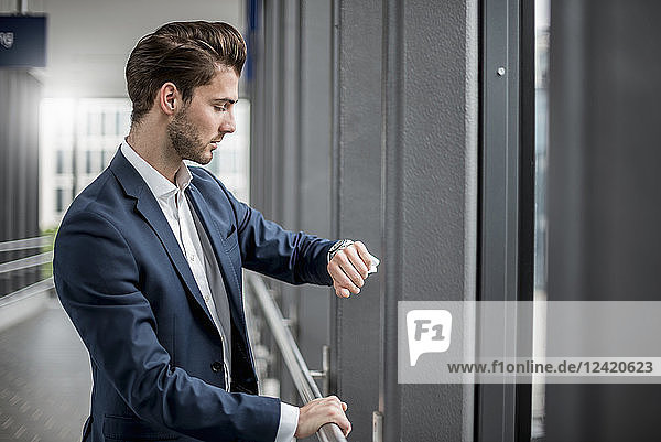 Businessman in a passageway checking the time