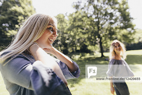 Two happy young women in a park