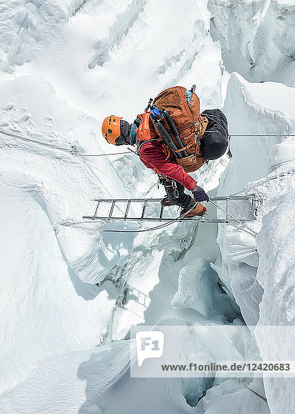 Nepal  Solo Khumbu  Everest  Sagamartha National Park  Mountaineer crossing icefall at Western Cwm