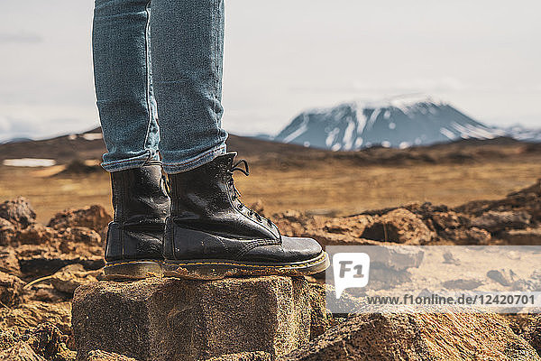 Iceland  woman standing on volcanic rock