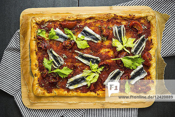 Pizza Marinara garnished with anchovies and parsley