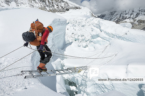 Nepal  Solo Khumbu  Everest  Sagamartha National Park  Mountaineer crossing icefall at Western Cwm