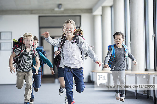 Excited pupils rushing down school corridor