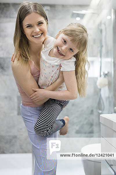 Mother and daughter having fun in the bathroom