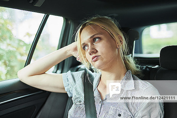 Serious blond young woman in a car