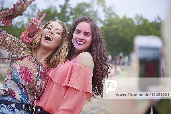 Portrait of happy women at the music festival  photographing