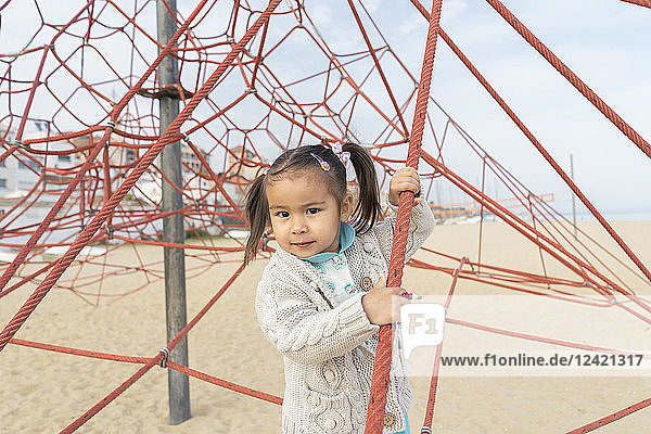 Portrait of little girl in climbing frame