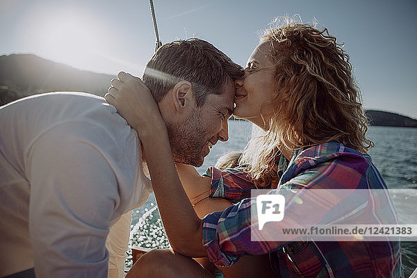 Affectionate couple with son on a sailing boat