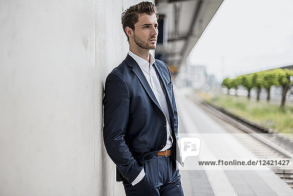 Businessman waiting at train station