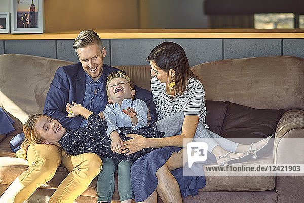 Happy family relaxing on the couch at home