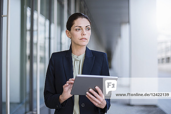 Portrait of serious businesswoman with tablet
