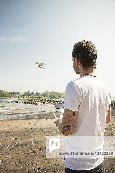 Man flying drone at a river