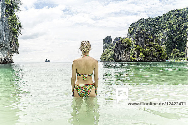 Thailand  Ko Hong  back view of woman standing in the sea looking to horizon