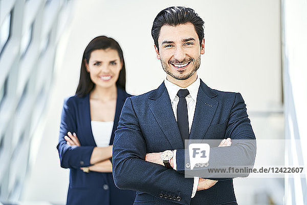 Portrait of smiling businessman and businesswoman