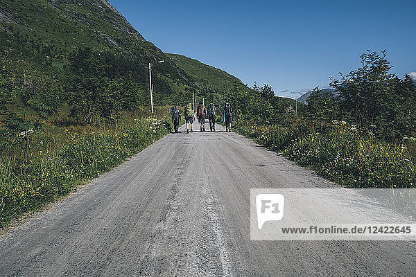Norway  Lofoten  Moskenesoy  Young men hiking on road to Selfjord
