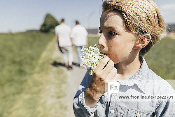 Boy with blossom in his mouth
