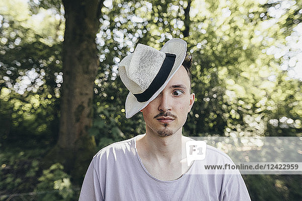 Portrait of silly young man wearing a hat