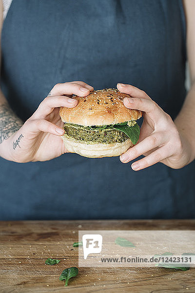 Woman holding homemade vegan burger