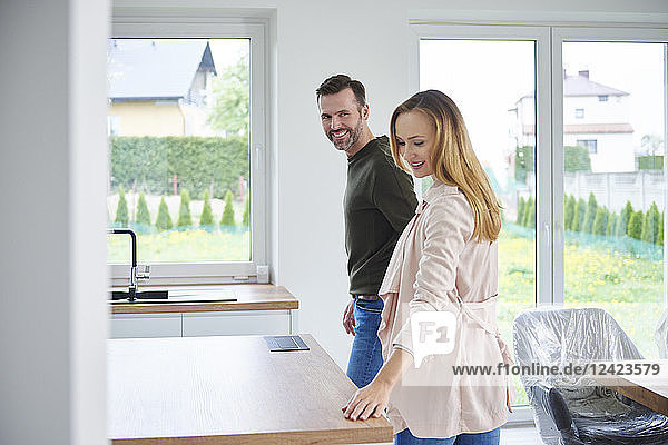 Couple examining kitchen in new flat