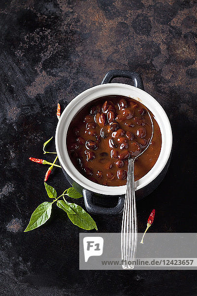 Tureen of black bean soup with chili pepper