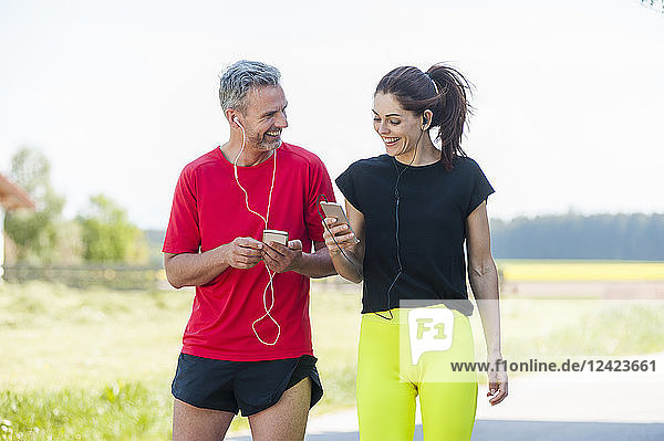 Couple using smartphones during workout