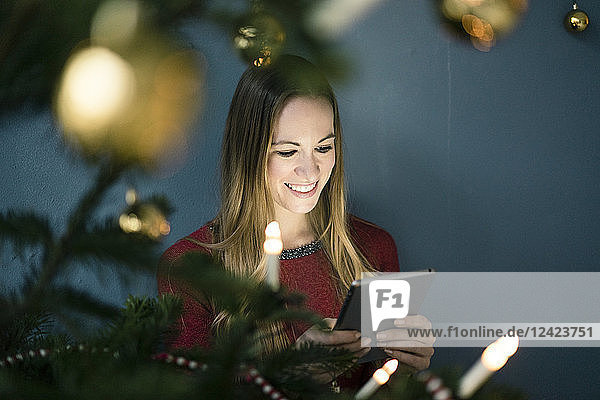 Portrait of smiling woman using tablet at Christmas time