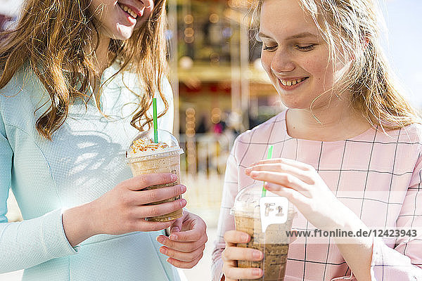 Russia  Moscow  teenage girls drinking a delicious frappe at funfair