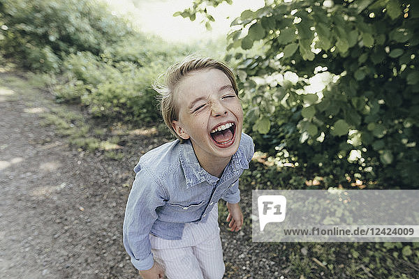 Laughing boy on forest path