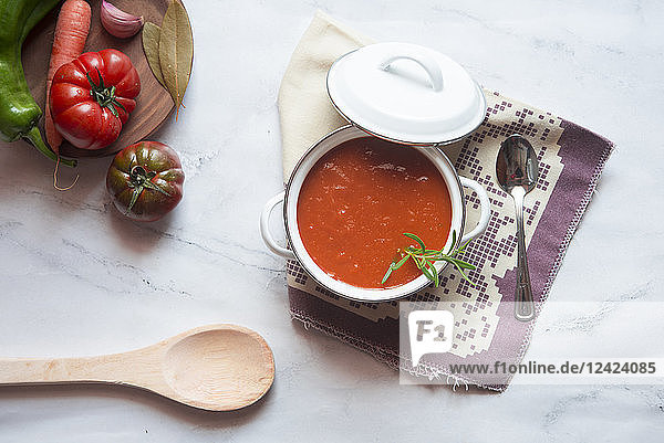 Cooking pot of homemade tomato soup on marble