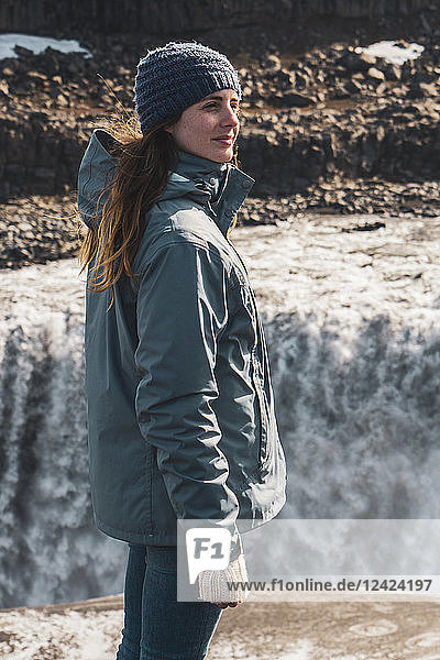 Iceland  woman standing at Dettifoss waterfall