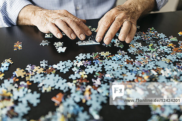 Senior man doing a jigsaw