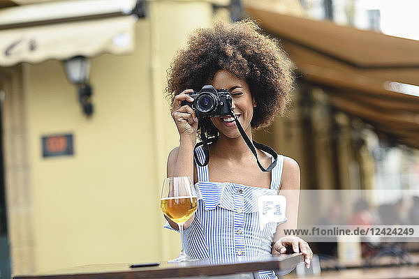 Young woman taking photo with camera outdoors