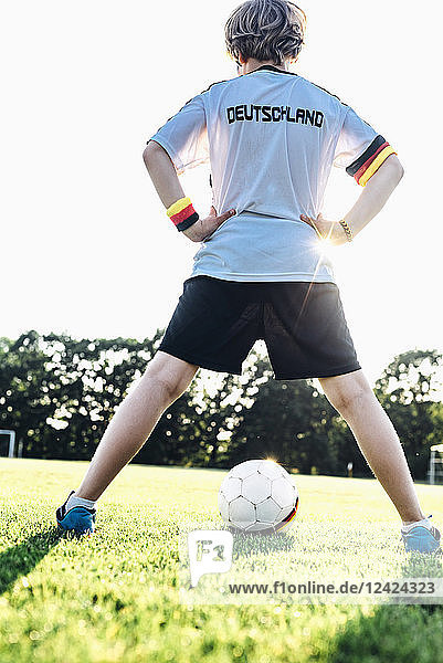 Boy wearing football shirt with Germany written on back