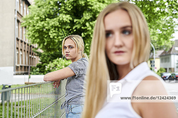 Two discontented young women outdoors