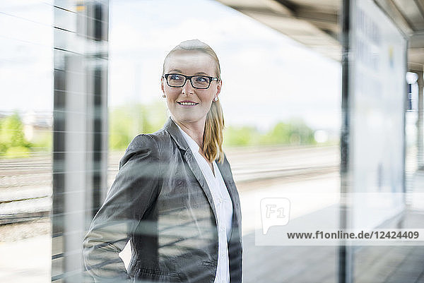 Portrait of smiling businesswoman waiting at platform