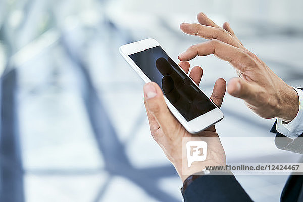 Close-up of businessman using cell phone