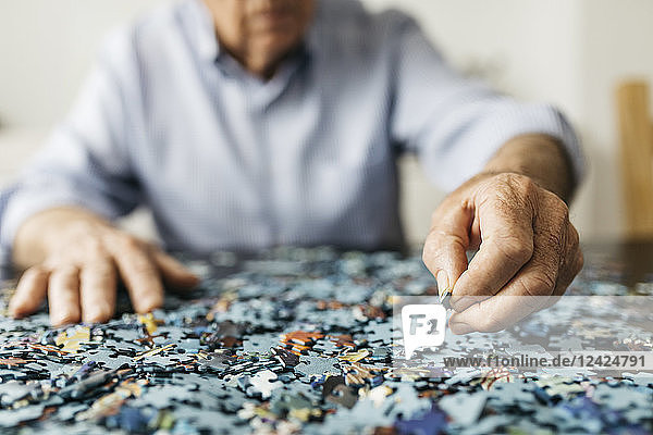 Senior man doing a jigsaw