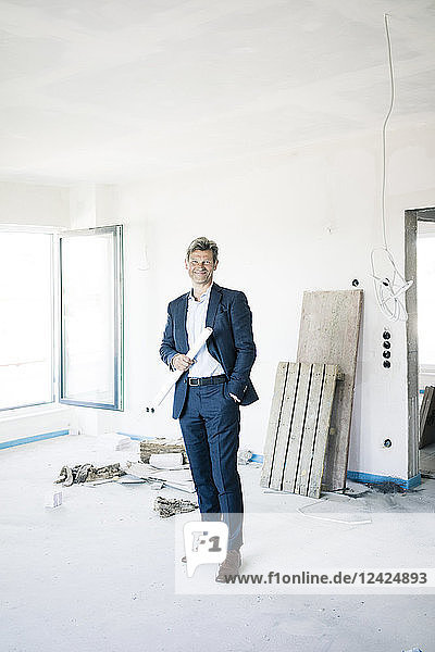 Portrait of smiling architect in building under construction