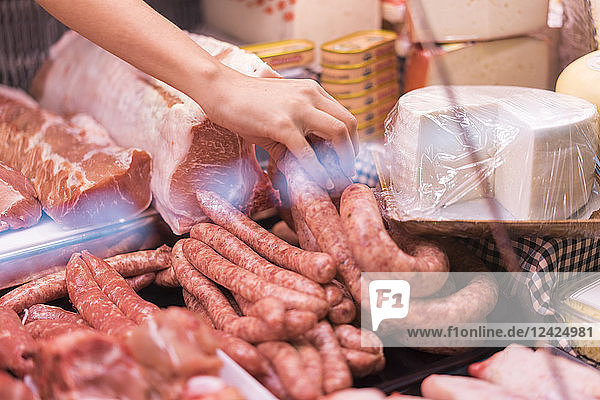 Female butcher with sausage