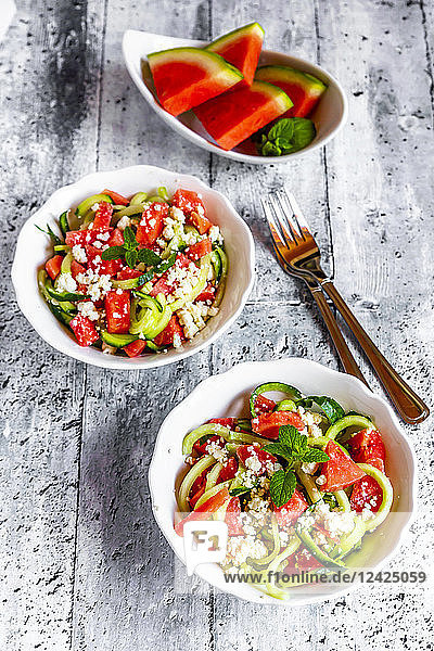 Two bowls of salad with watermelon  cucumber  feta and mint