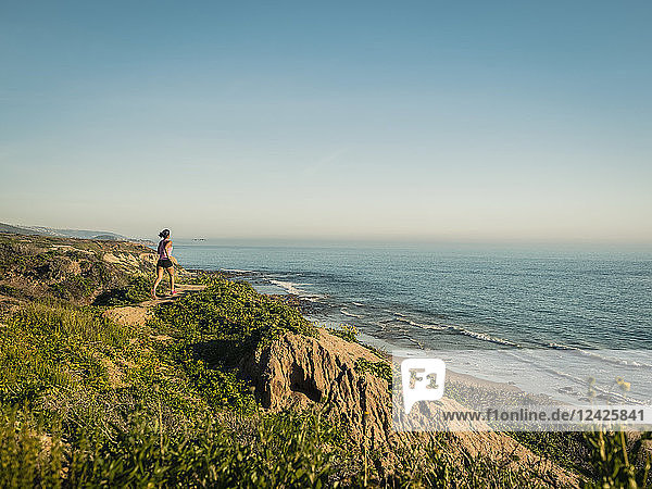 USA  Kalifornien  Newport Beach  Frau läuft entlang Klippe