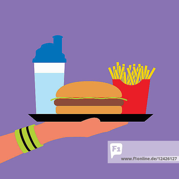 Hand wearing wristband holding fast food on tray